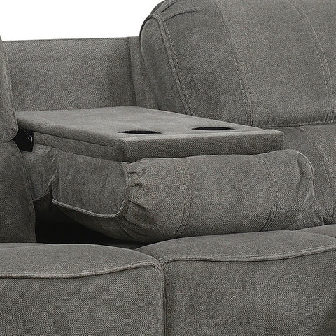 Close-up of a gray upholstered reclining sofa with a center armrest folded down into a storage ottoman featuring two cup holders, set against a plain white background.
