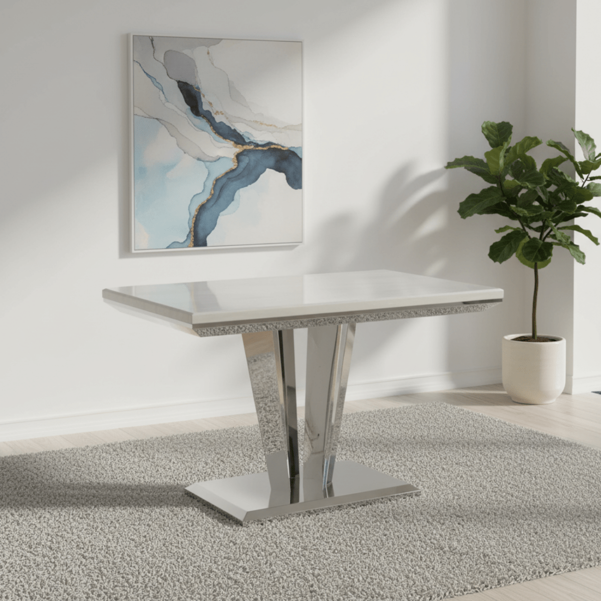 Modern dining table with a white marble-like top and chrome legs on a white background