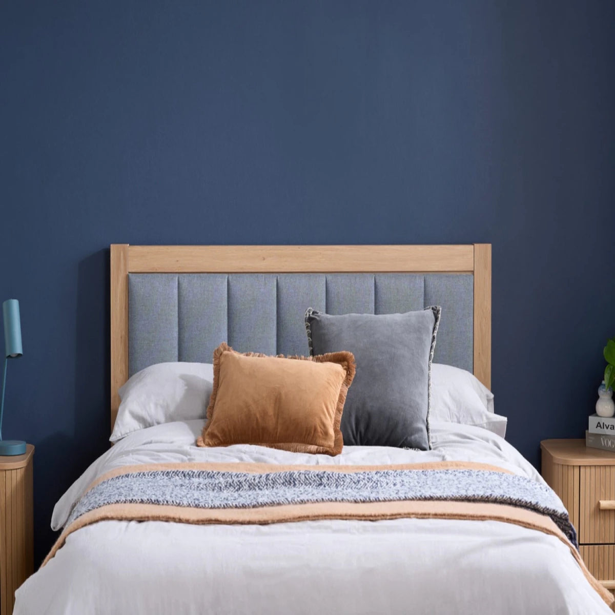 Elegant grey upholstered headboard with soft cushioned finish.