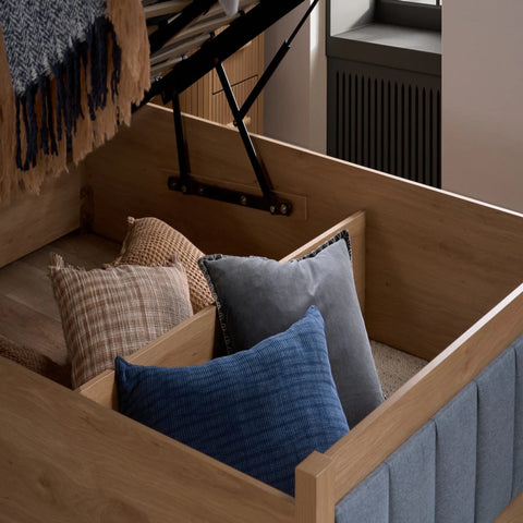 Deep hidden storage compartment beneath mattress base.